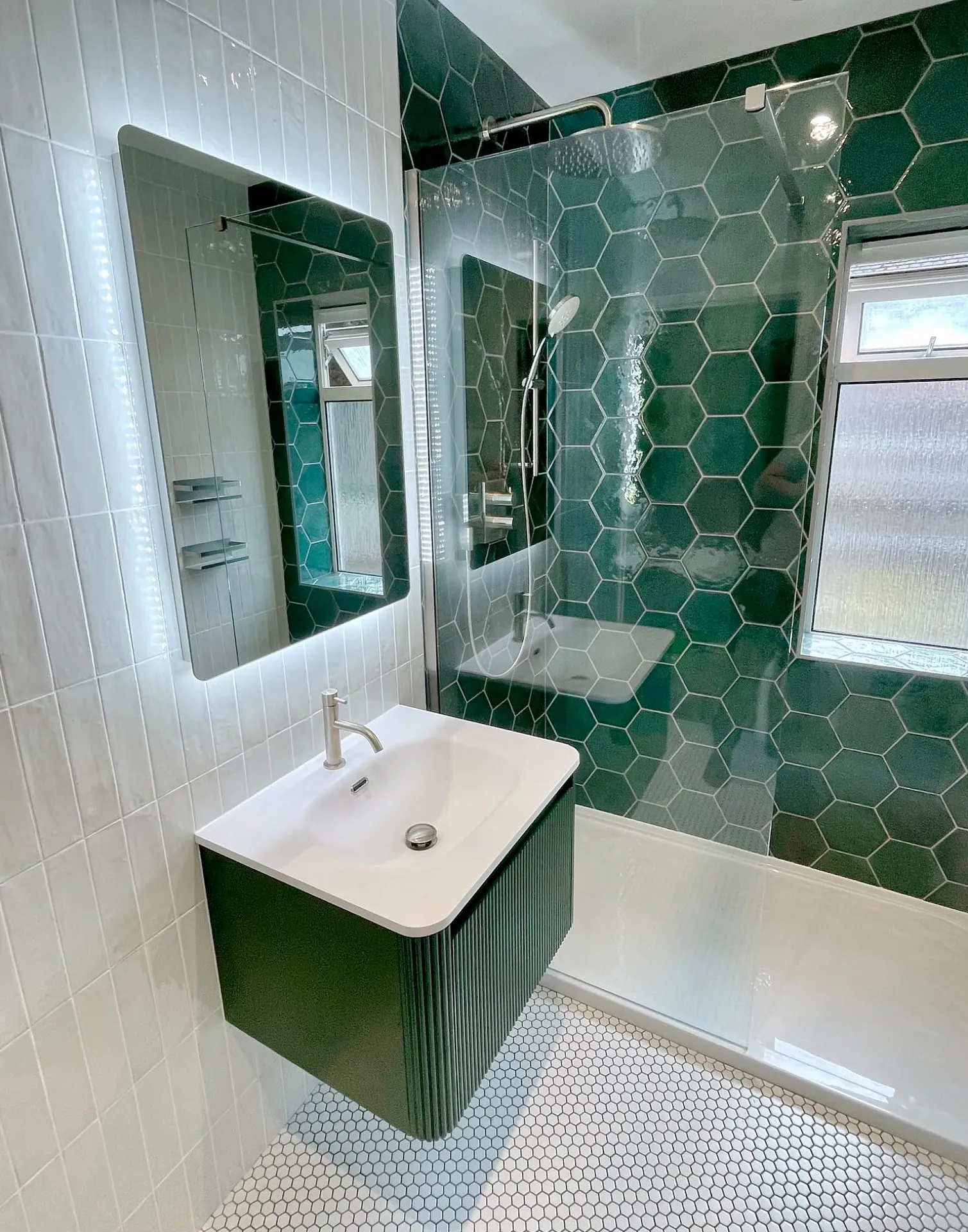 Green hexagon-tiled shower and fluted vanity fitted by JM Bathrooms in Haywards Heath